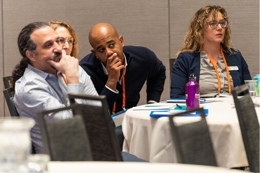 Conference attendees listening intently