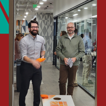 Billy Hensley and JJ McGinnis playing cornhole in the NEFE office