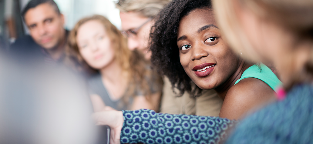 Group of adults gather to discuss the importance of collaboration.