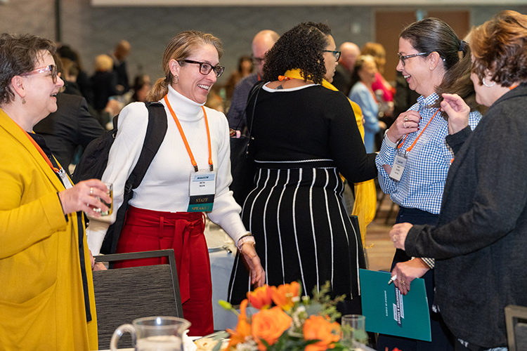 A small group of conference attendees discussing session.